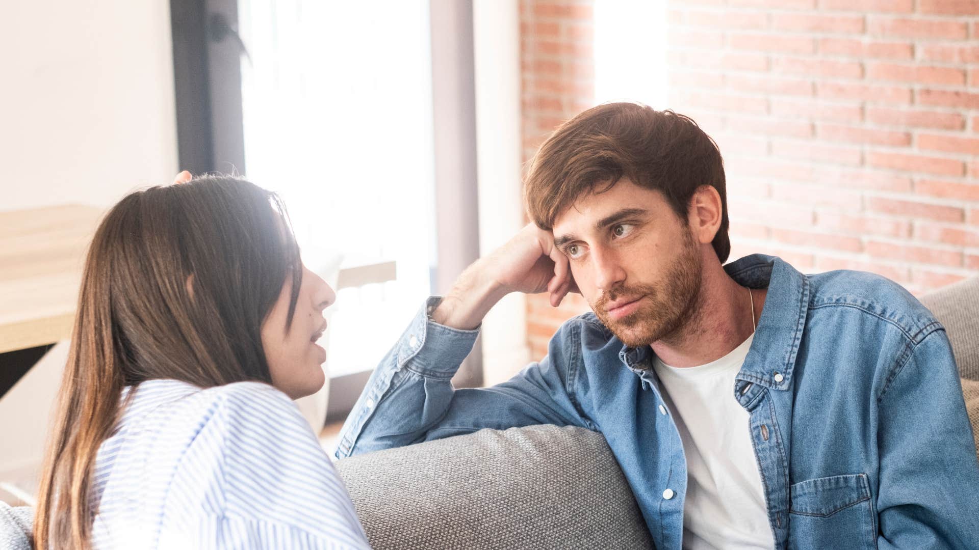 gen z man with passive energy listening to woman talk