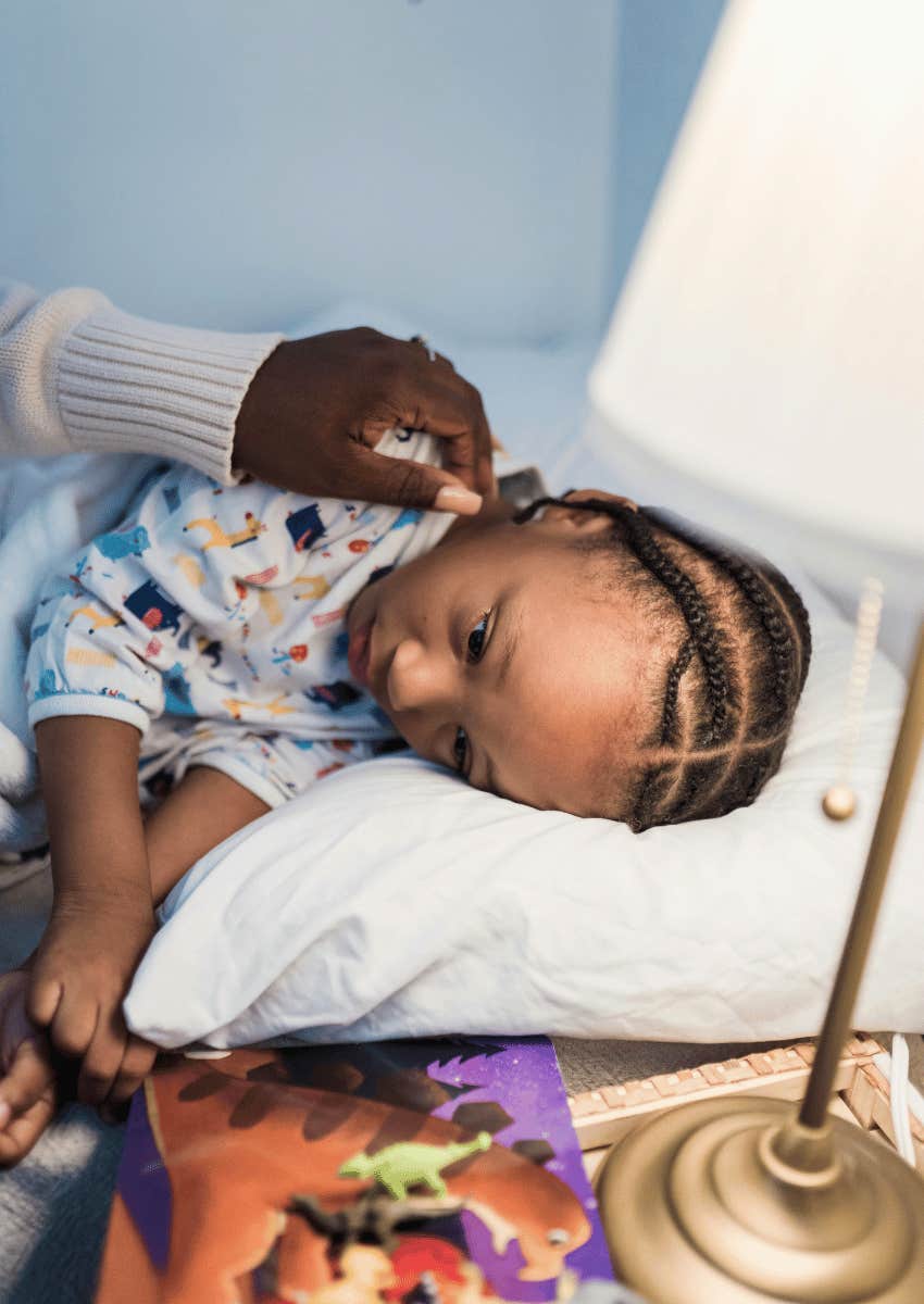 mother and child sitting next to bedside night lamp