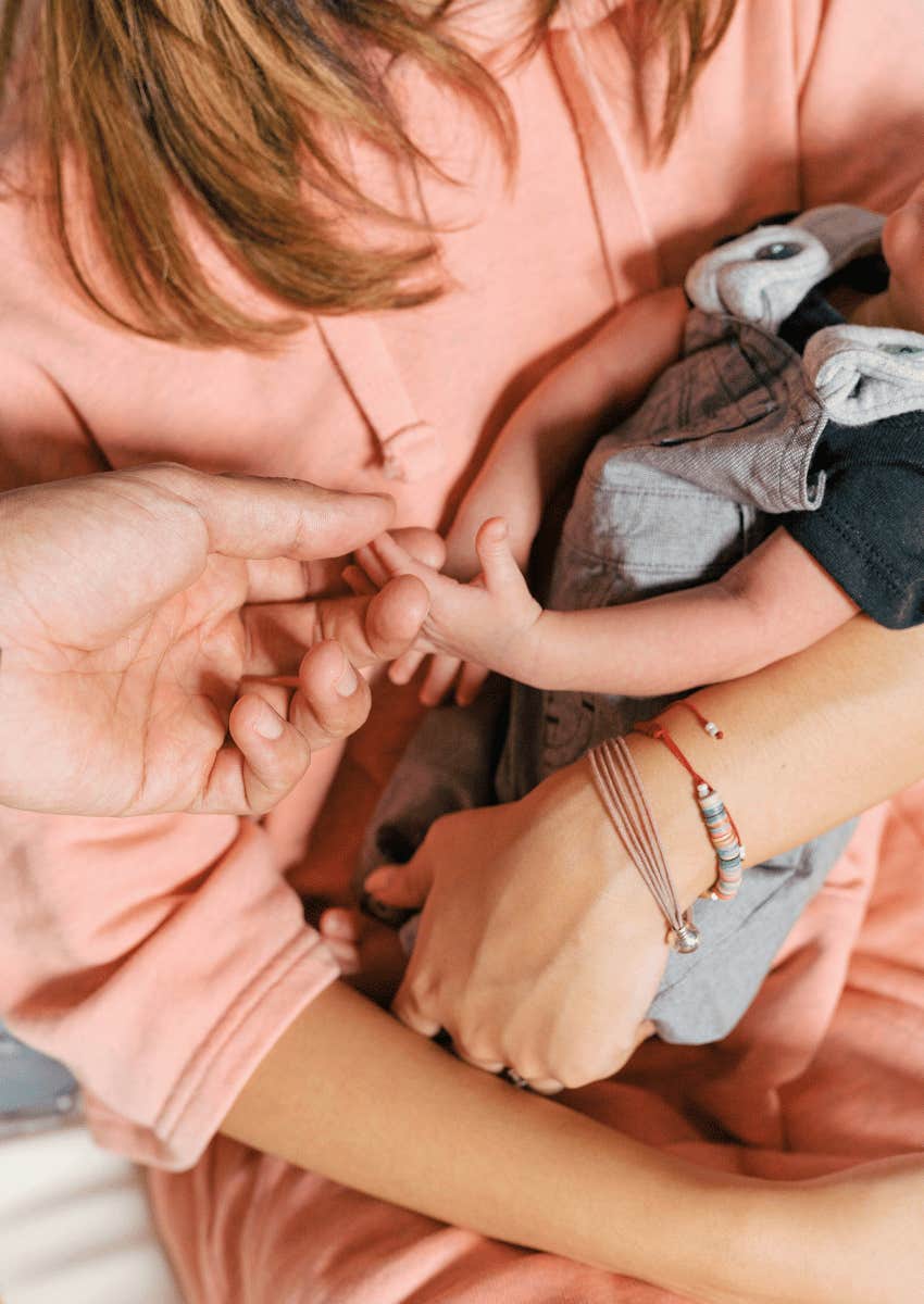 mother cradling her baby close in her arms