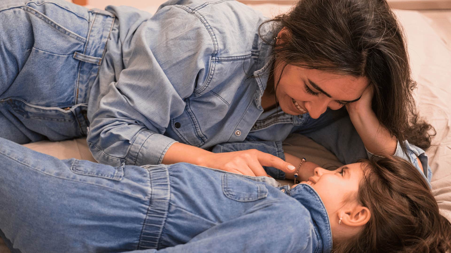 mother and daughter laying together