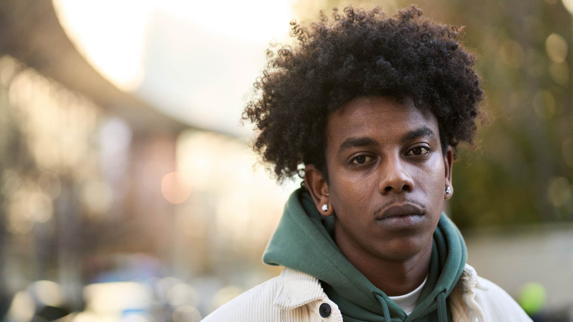 young narcissistic man standing outside