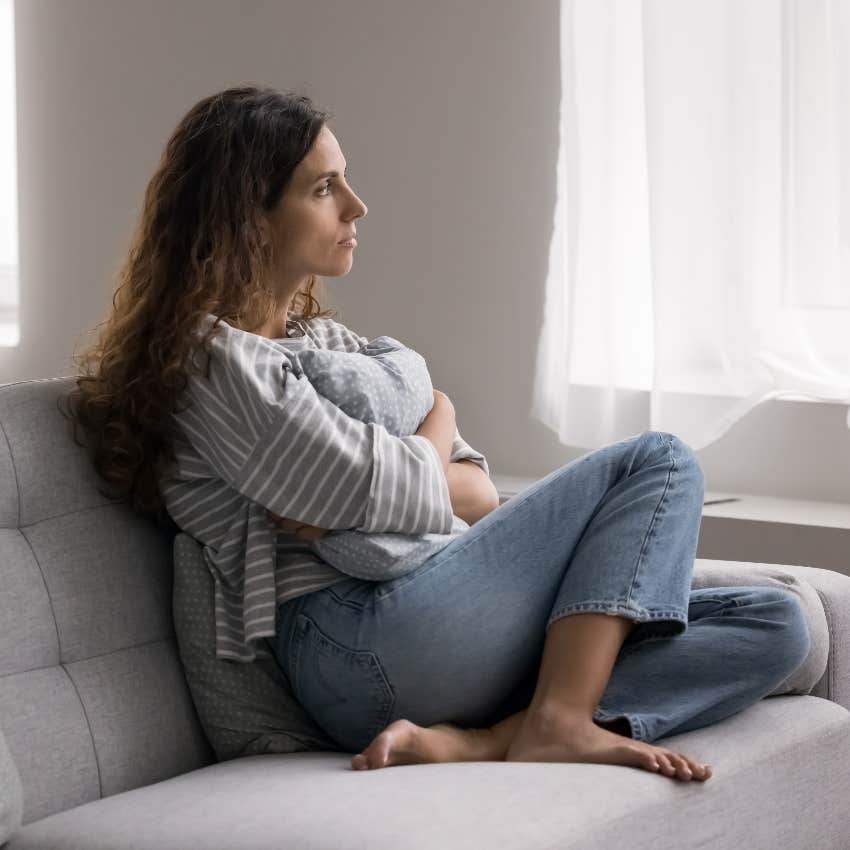 lonely woman sitting on couch wants to be alone