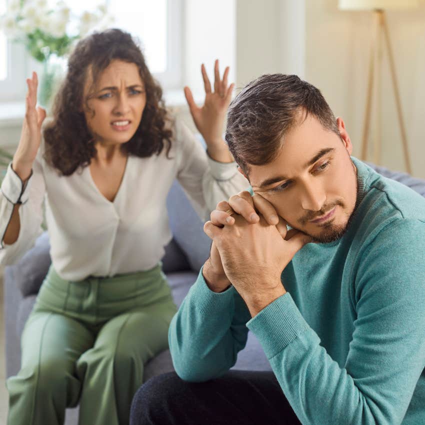 man feeling depressed while girlfriend argues with him
