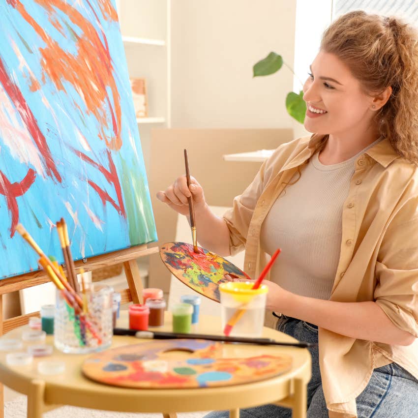woman improving attention span by engaging in painting hobby