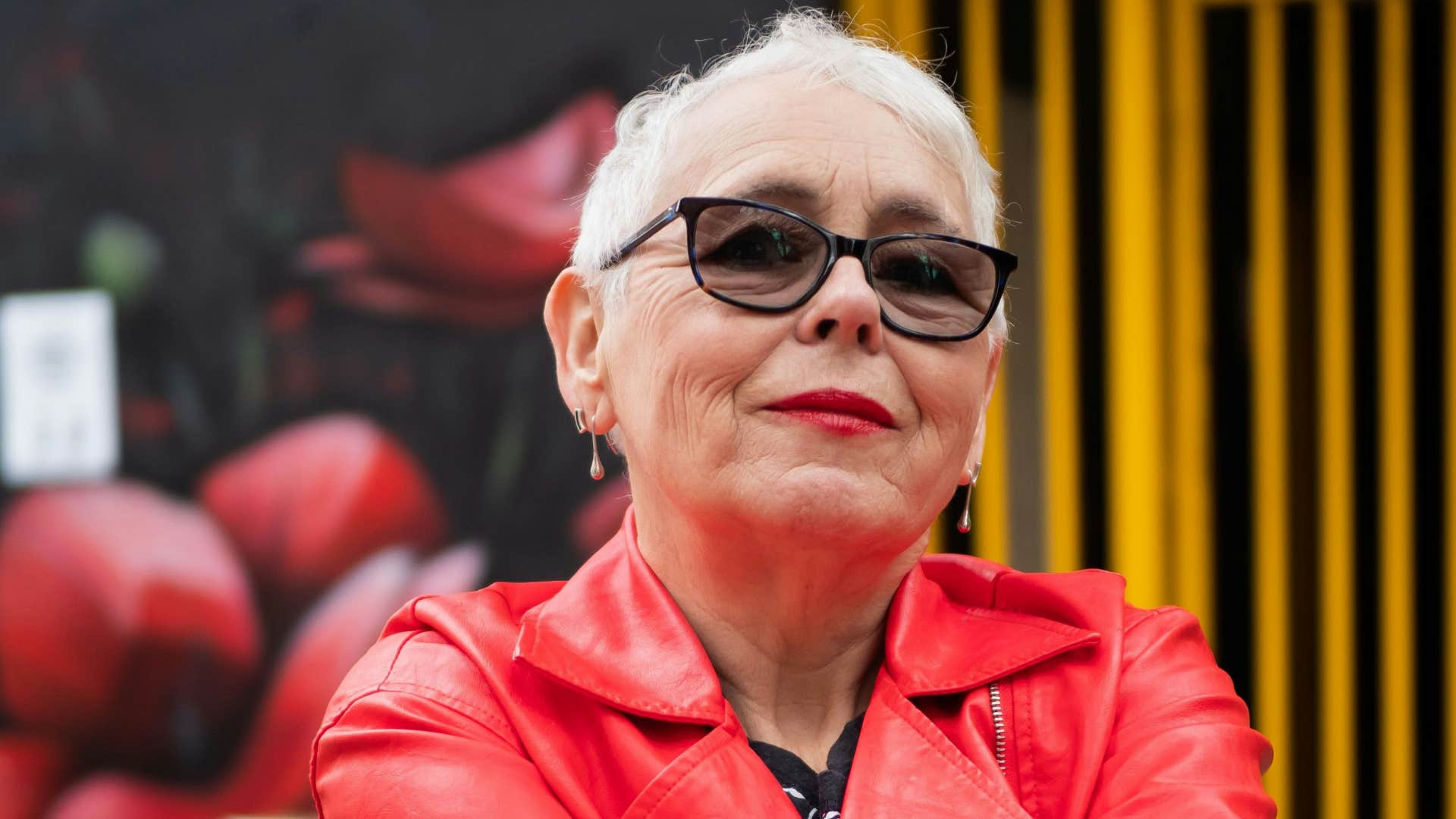 stylish older woman grins knowingly