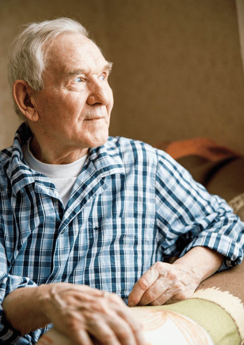 older man looking out of window