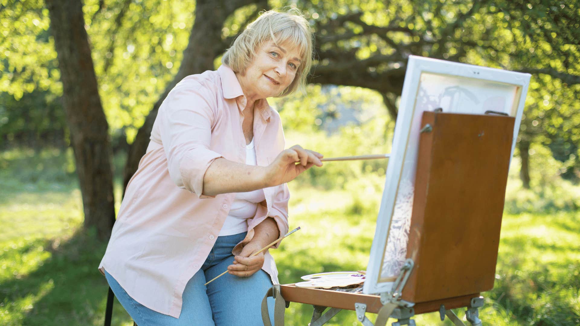 older woman painting regretting sacrificing her hobbies