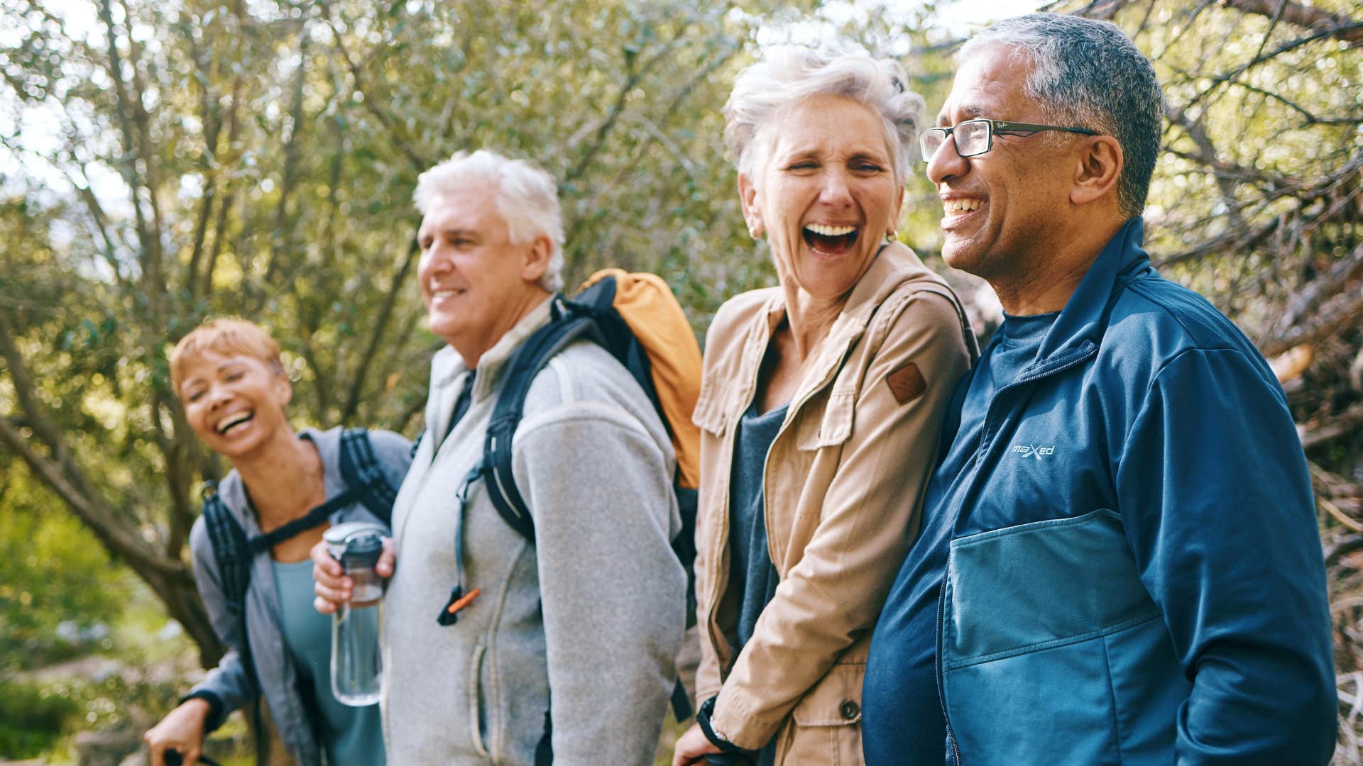 people on nature hike laughing for energy
