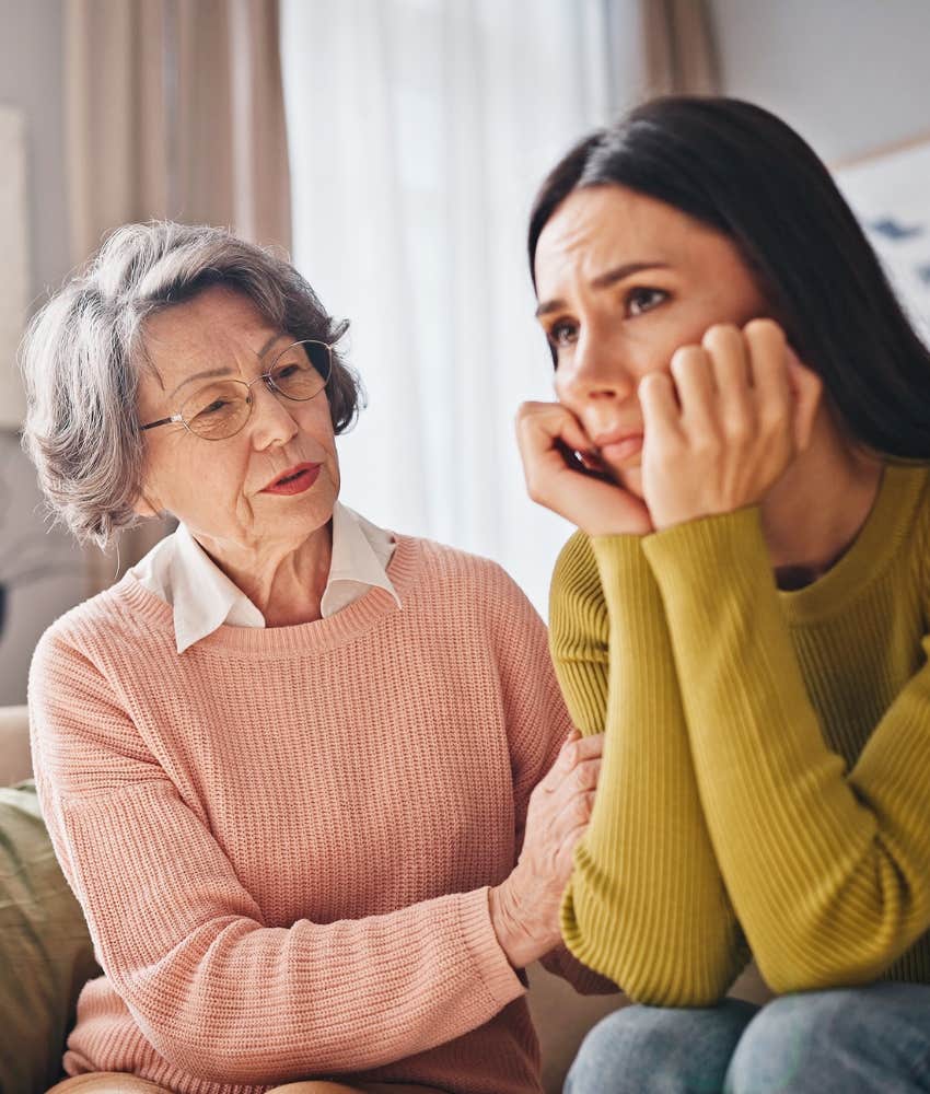 Kind older person silently supports sad younger person