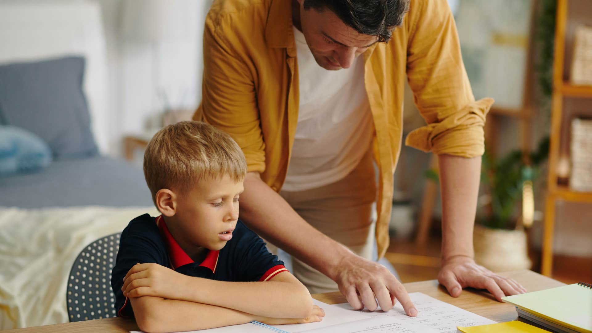 modern dad helping son with homework