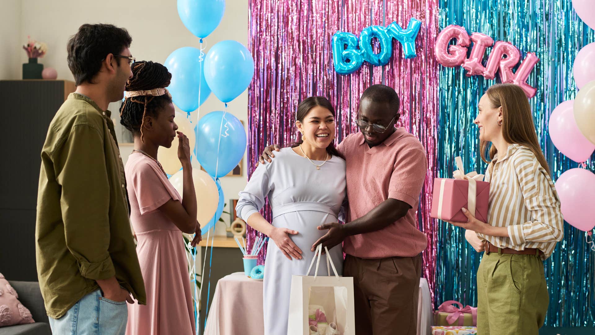 couple throwing gender reveal party