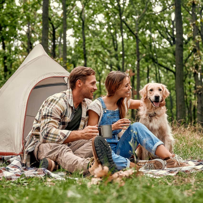couple camping with dog happy in their decision not to have kids