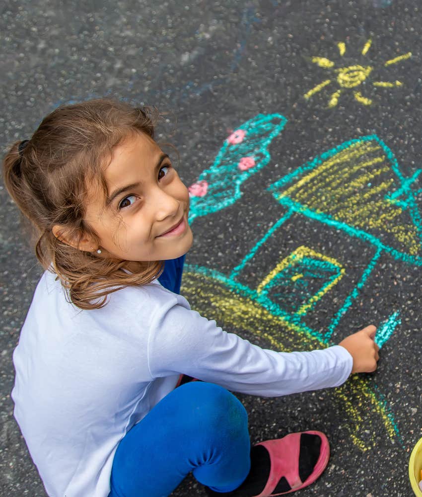 kids draws house with chalk on sidewalk showing appreciation 