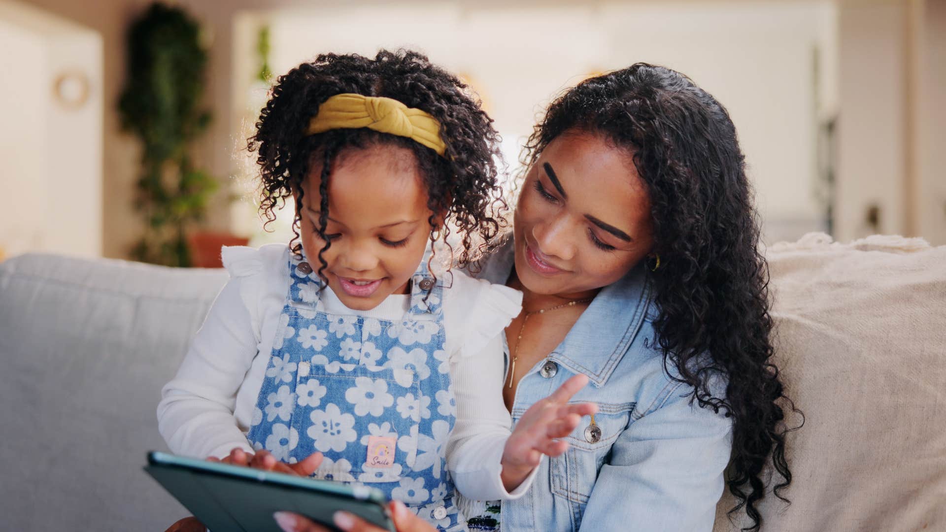 child and parent use tablet for thinking skills