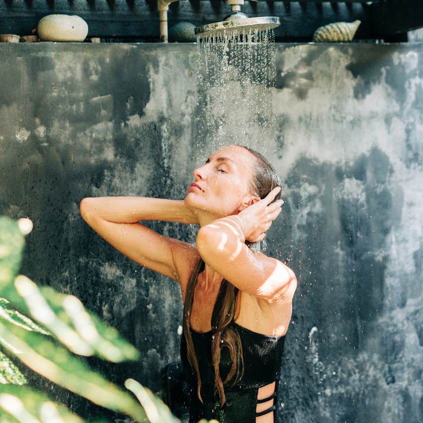 blonde woman using outdoor shower