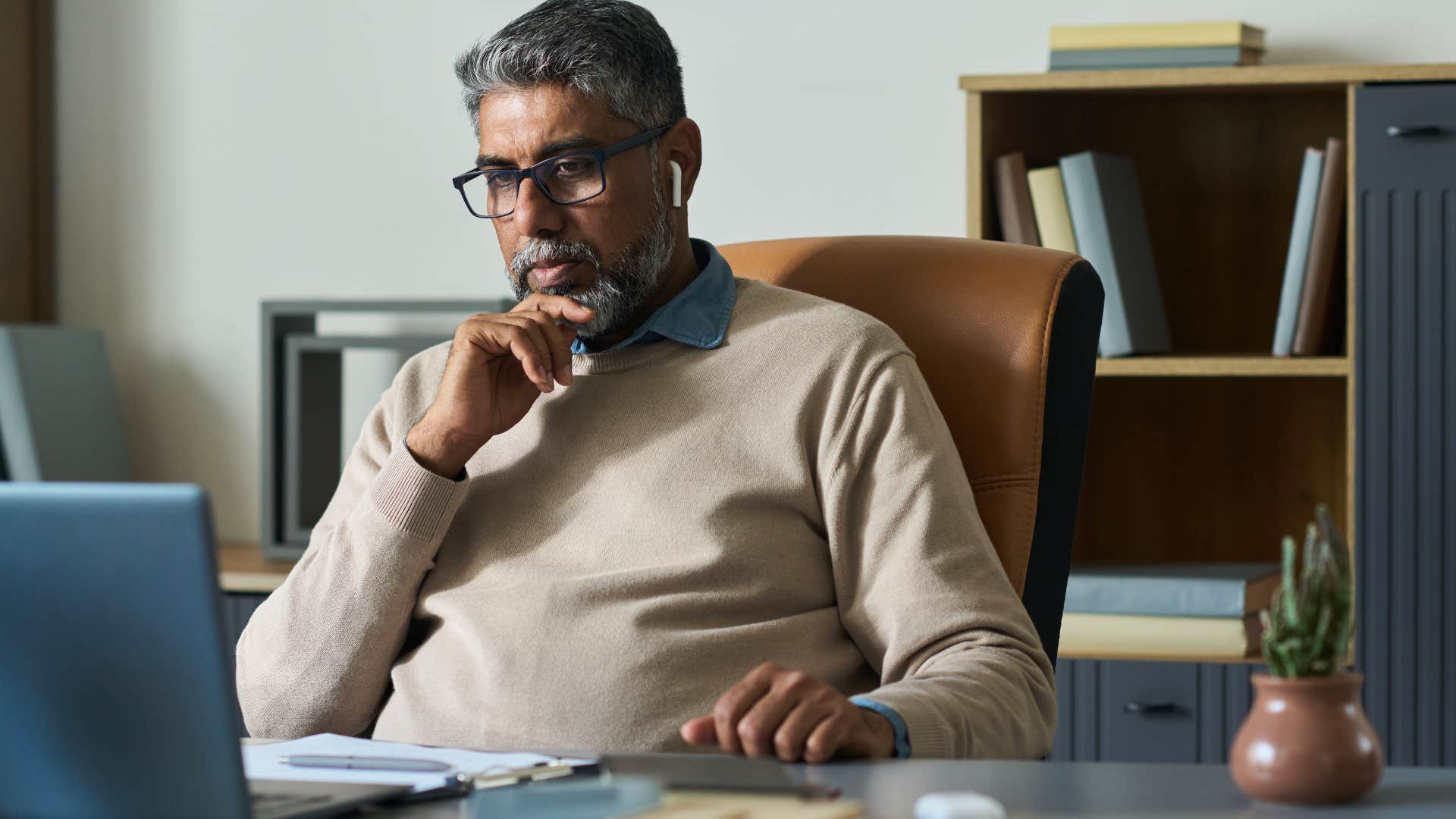 Man who's grown into technology working on a laptop.