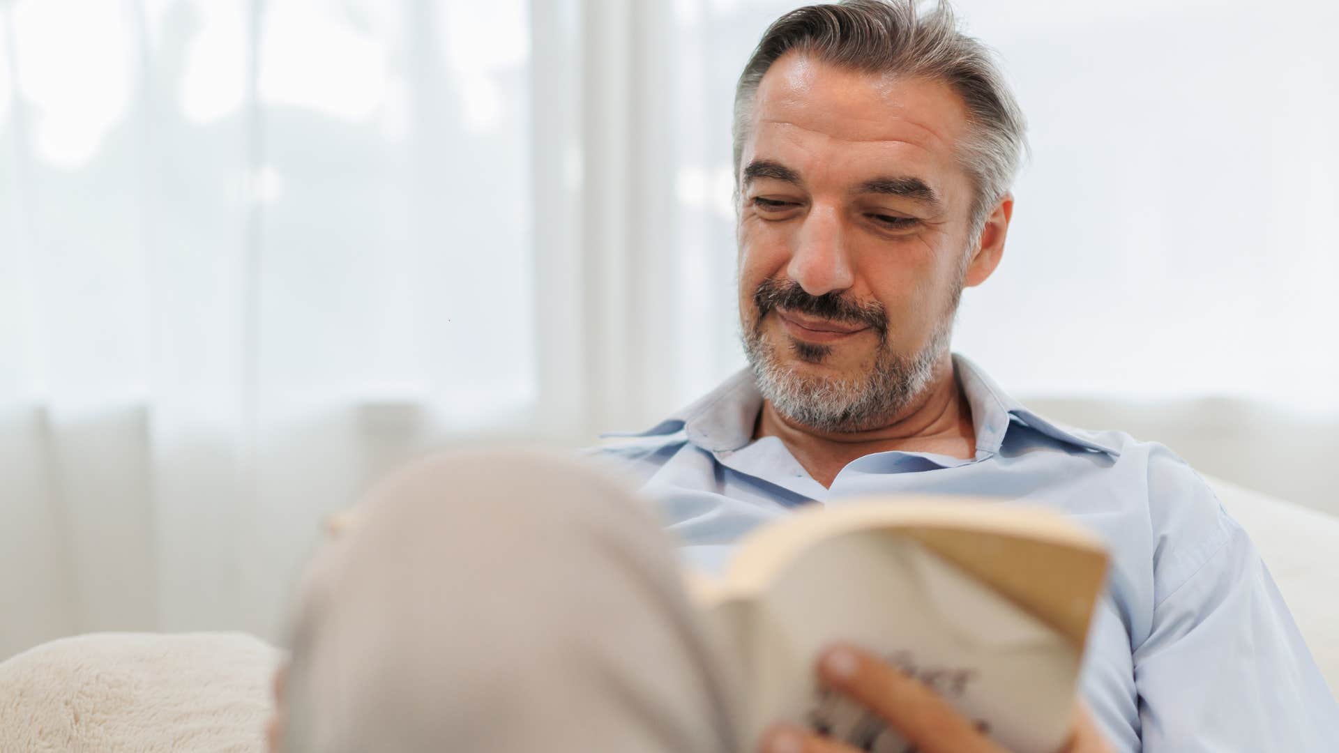 Man who knows how to research without AI reading a book. 