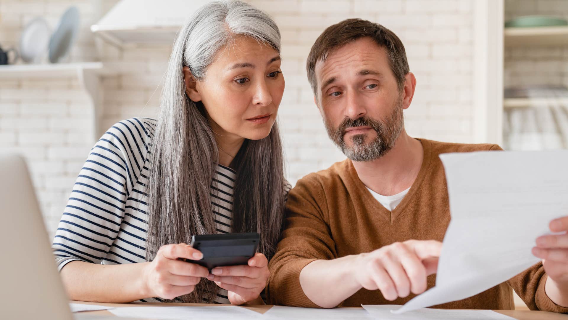 Financially literate Gen X couple doing bills.