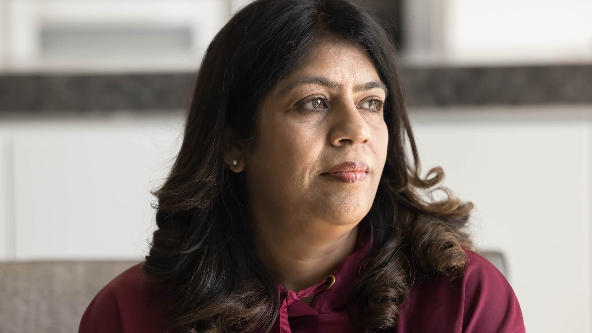 bored woman sitting at home enjoying alone time