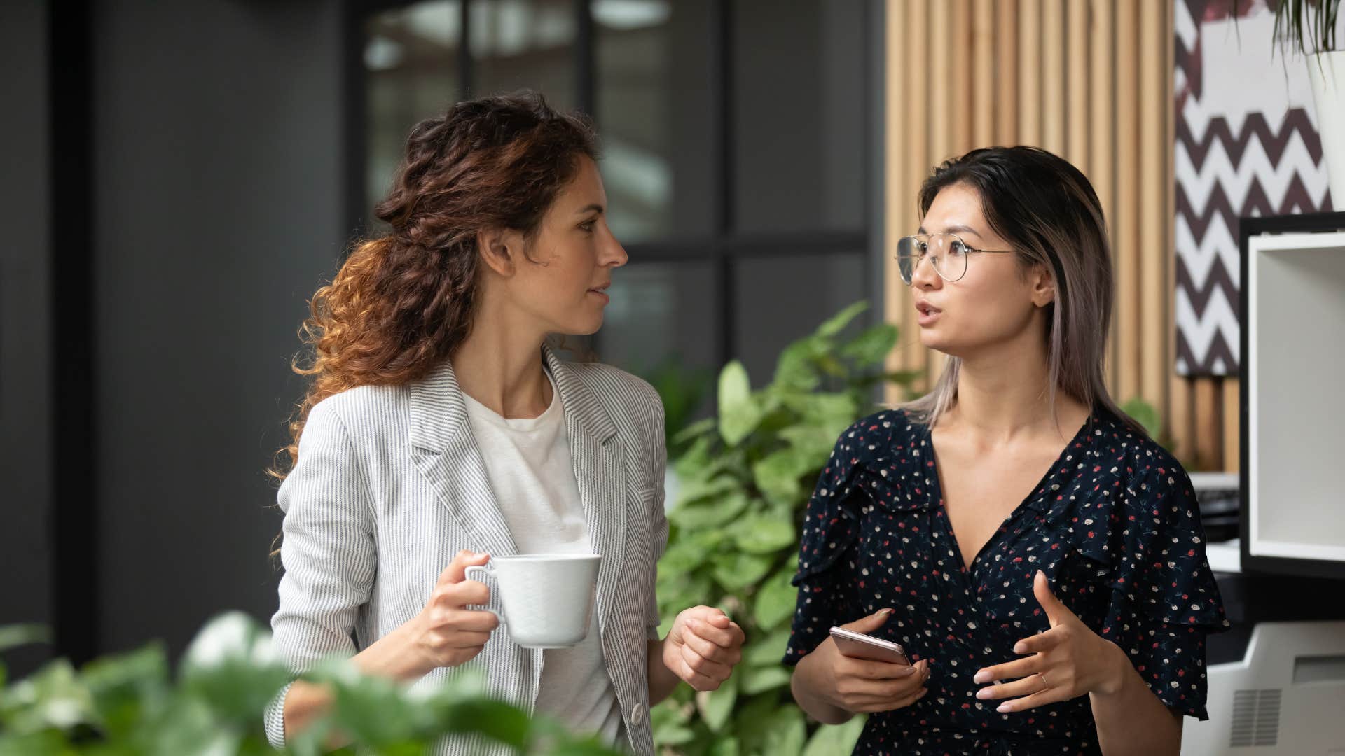 two coworkers talking respectfully as the younger generations are highly considerate of personal boundaries