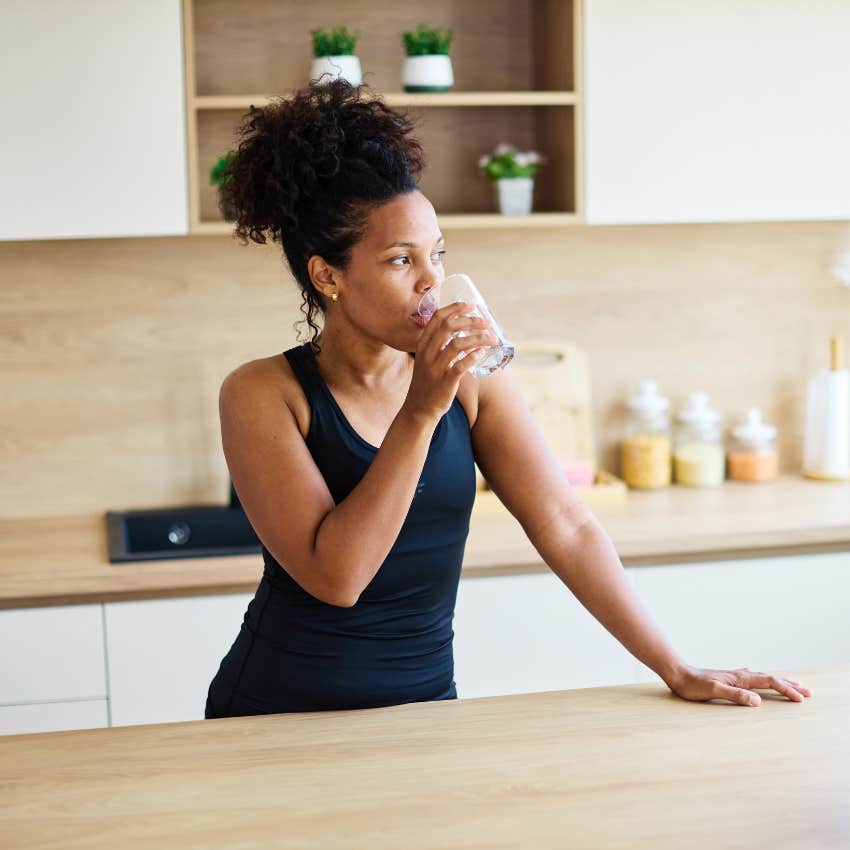 woman drinking water to avoid stress