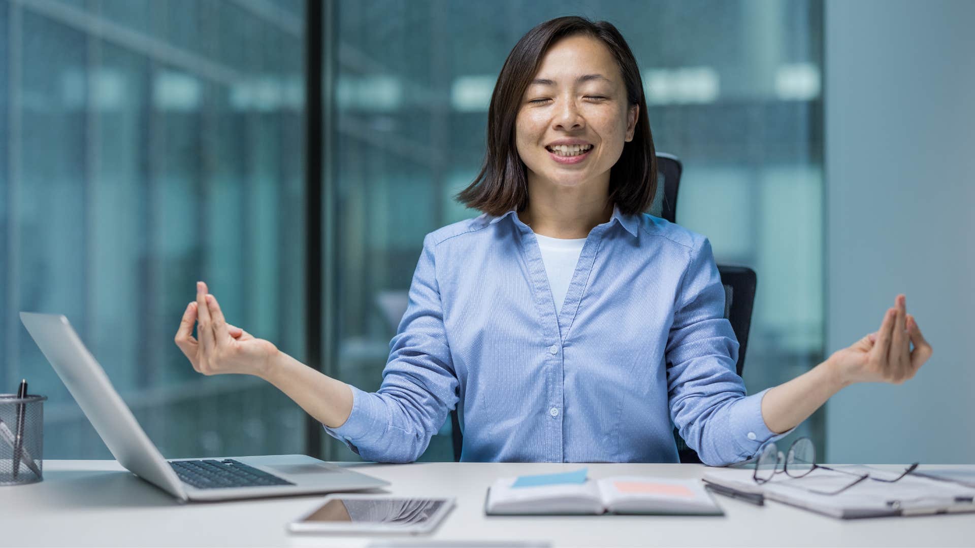 woman in blue shirt meditating as they trust their intuition