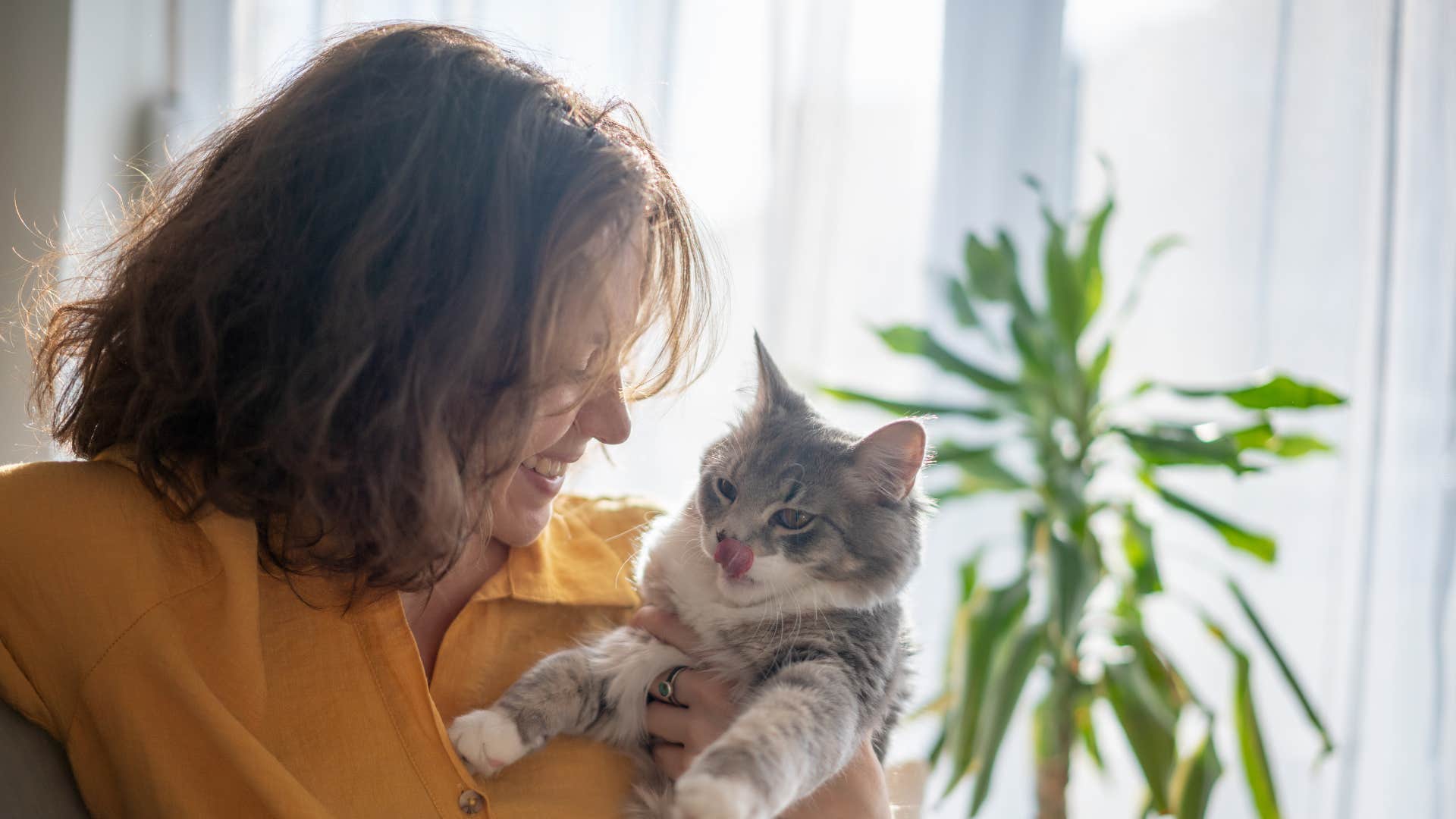 introverted woman who hates most humans but loves animals holding her cat