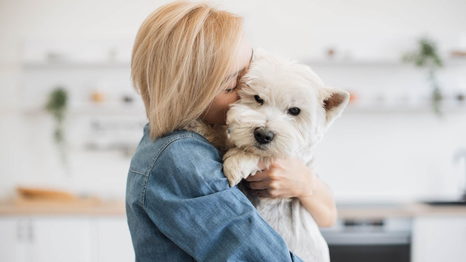 nurturing woman who hates most humans but loves animals hugging her dog