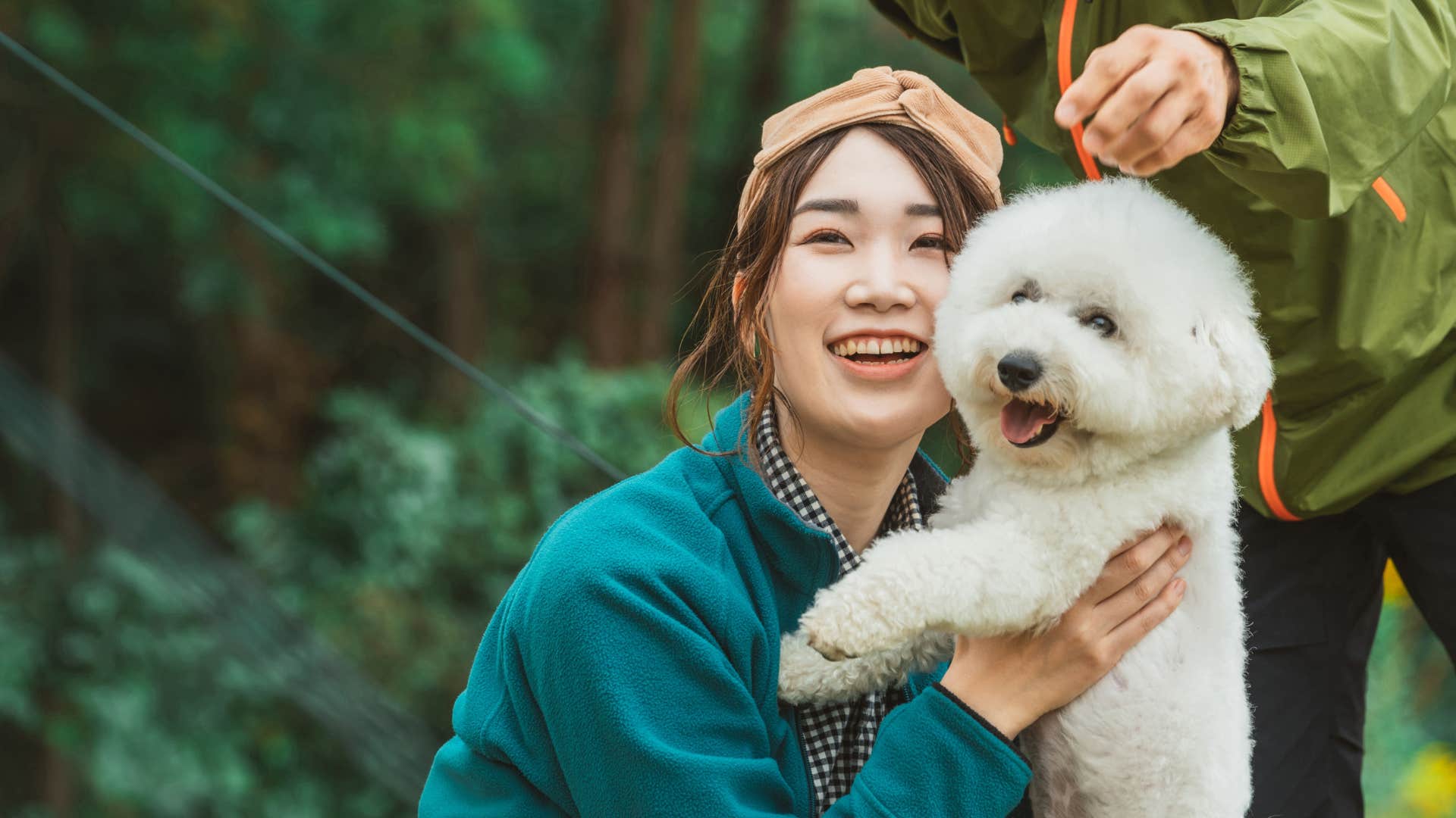 simple-minded woman who hates most humans but loves animals hugging her dog outside
