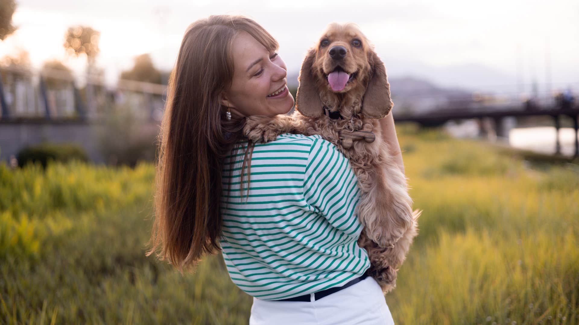 woman who hates most humans but loves animals hugging a dog outside