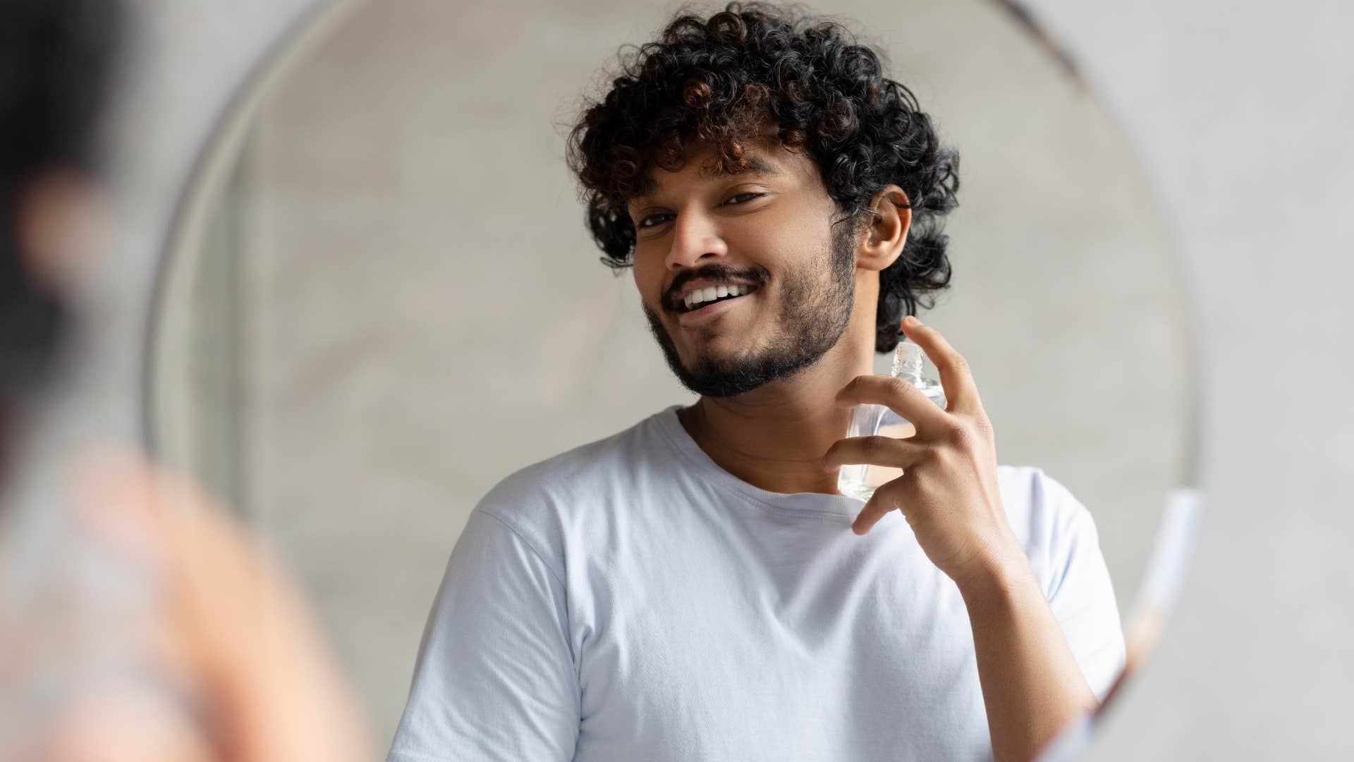 Man applying cologne that people will judge him for 