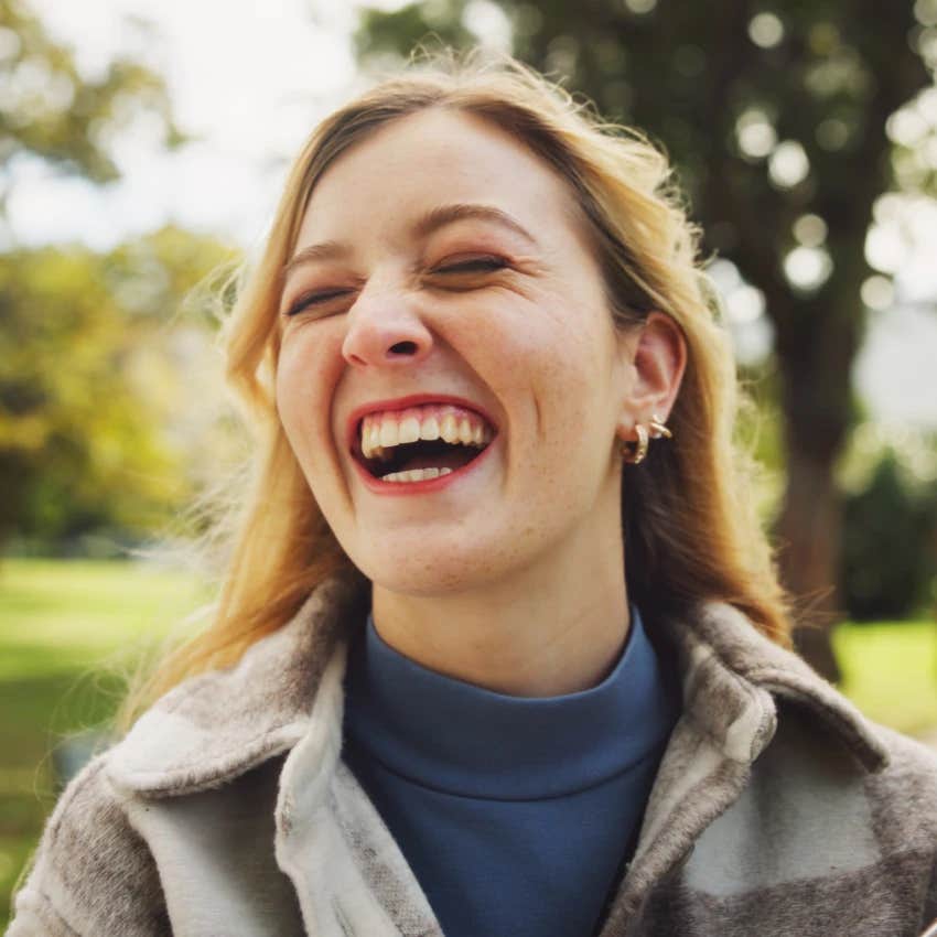 woman laughing at herself instead of getting embarrassed