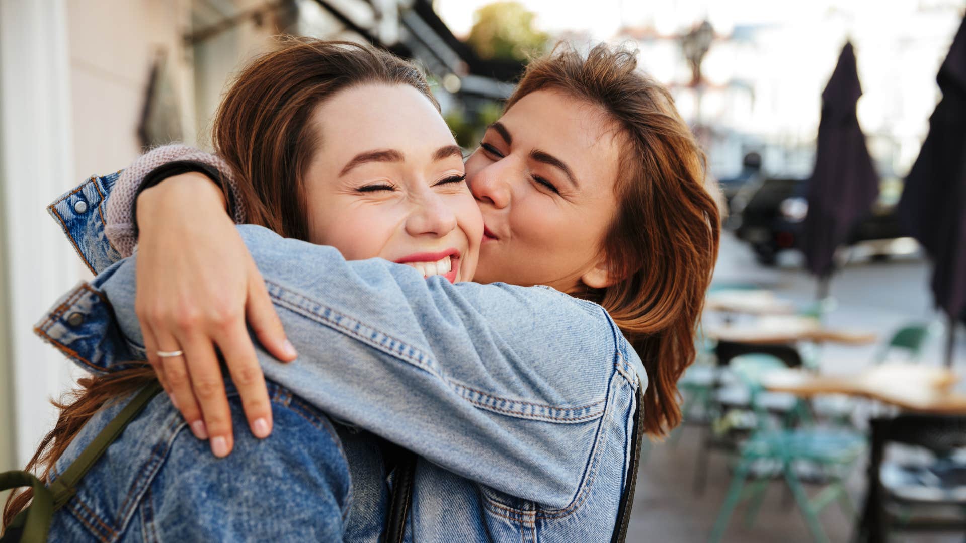 people pleasing woman hugging her friend smiling