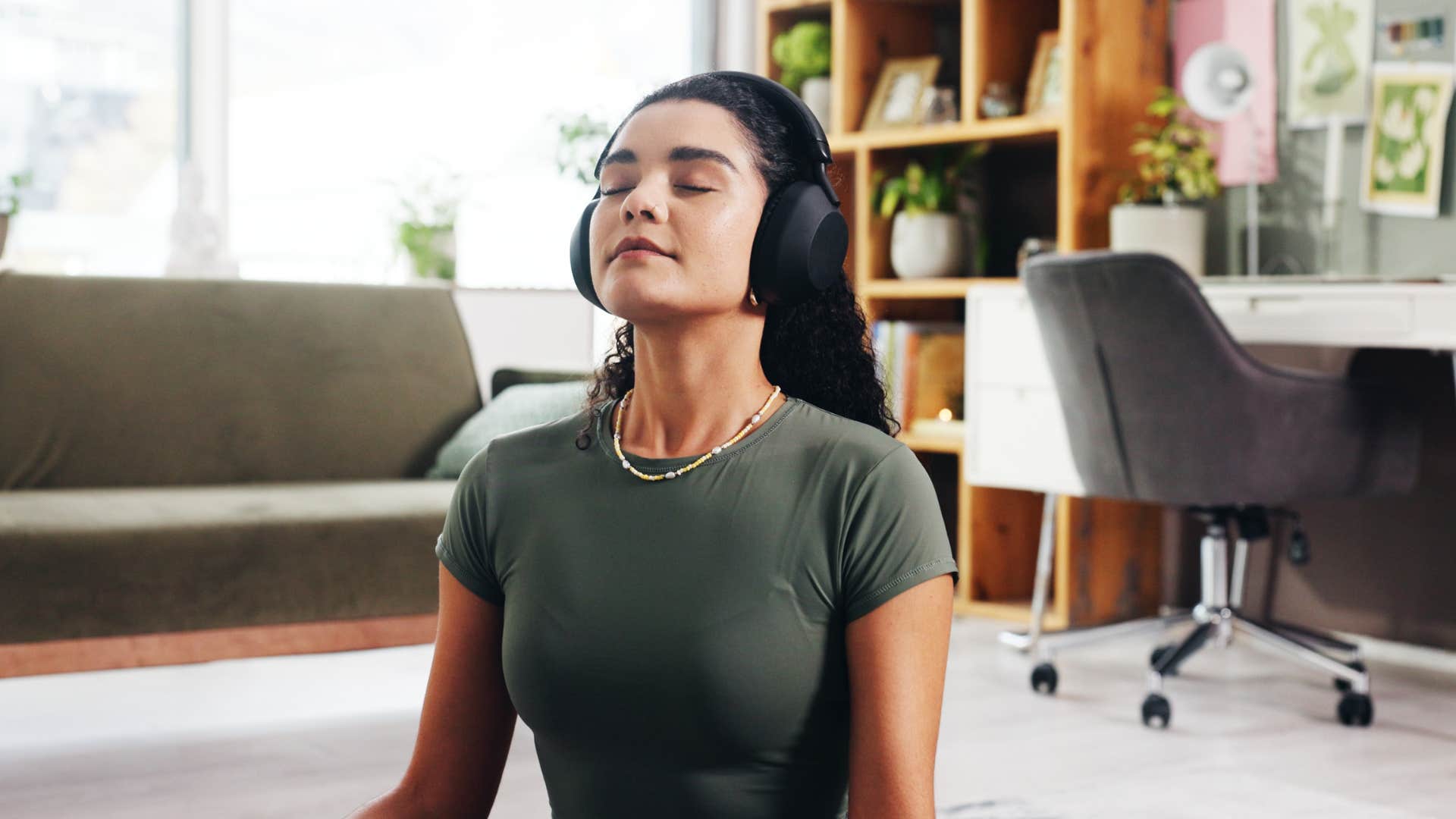 woman with a high tolerance for mess meditating at home