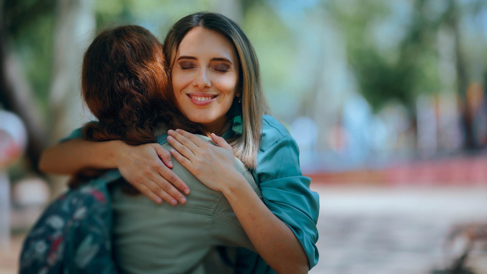 friends hugging as one friend has high empathy