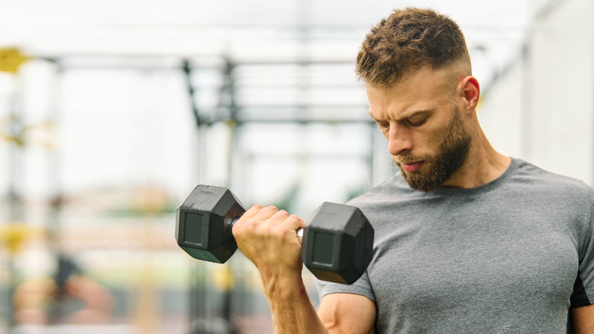man in gray shirt working out as he's highly disciplined