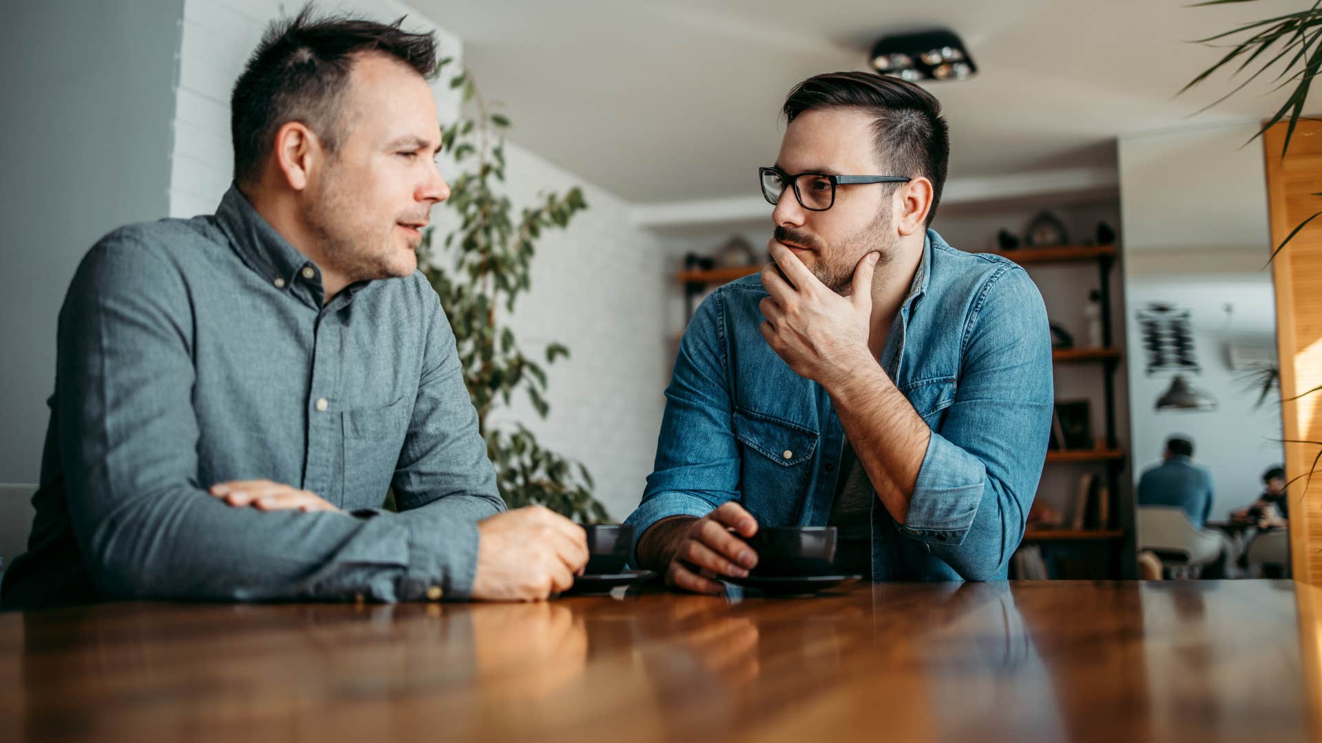two male coworkers talking as one has situational adaptability