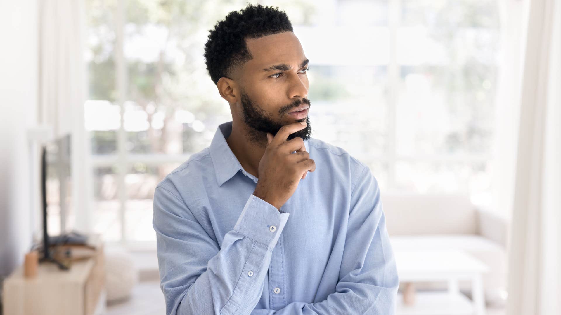 man who is an analytical thinker staring out the window