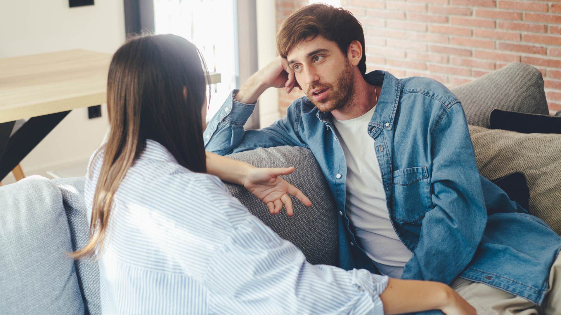 couple who are straightforward communicators talking on the couch