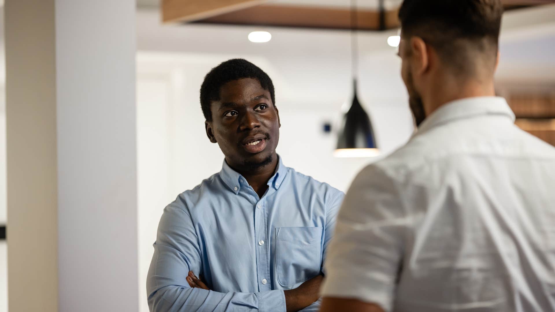 man with a no-nonsense personality talking to colleague