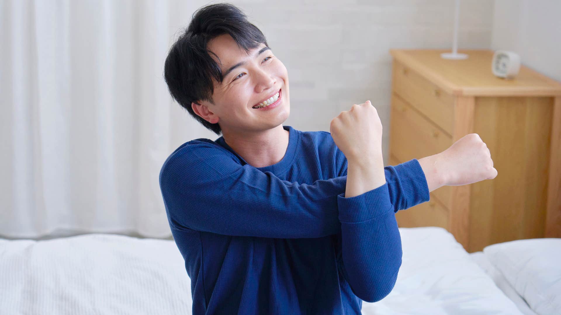 man with a high pain tolerance stretching in the morning