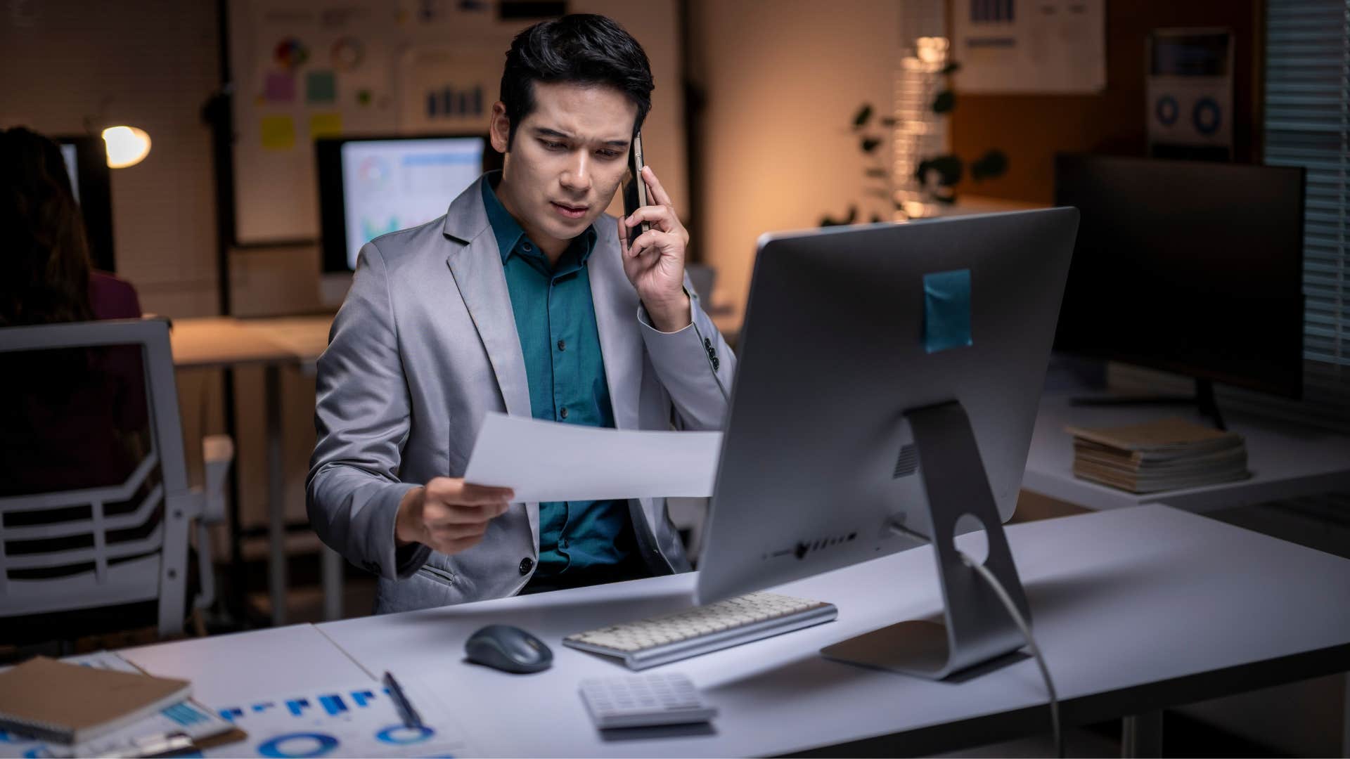 man sitting at desk on phone working as he's highly disciplined