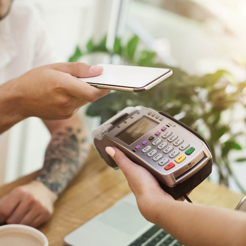 customer paying a tip with a credit card machine