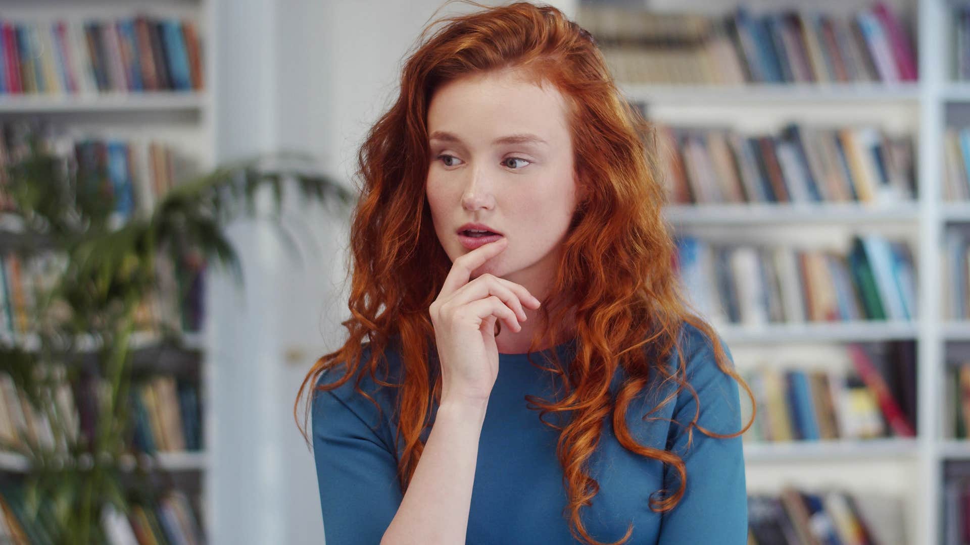 curious woman thinking at the library