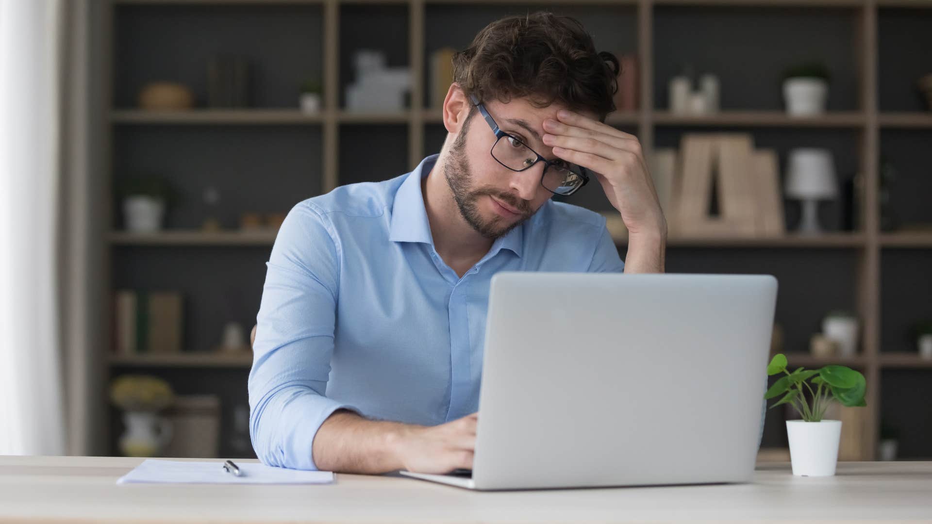 overthinking man feeling overwhelmed with work projects