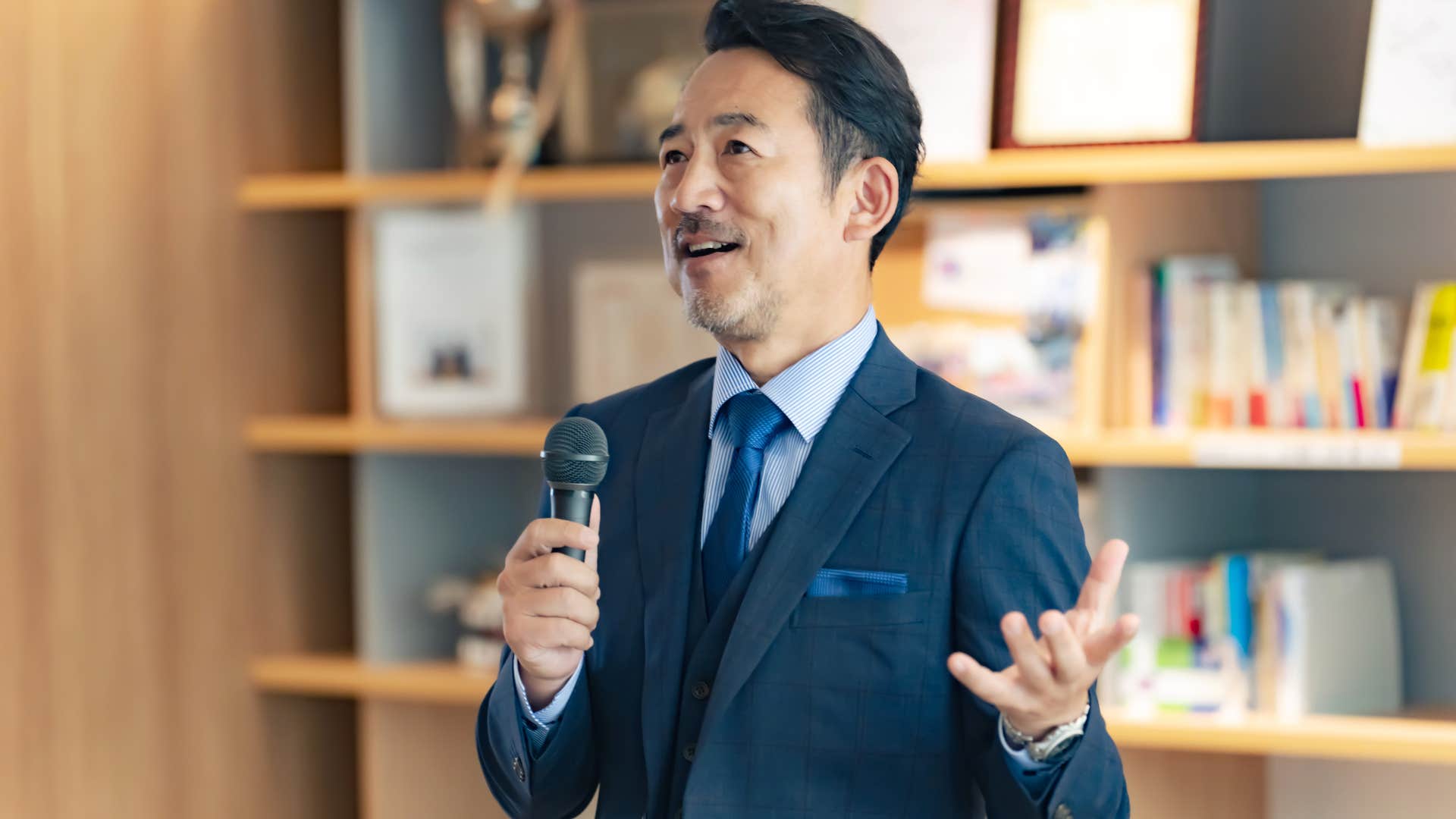 man talking on microphone about american policy