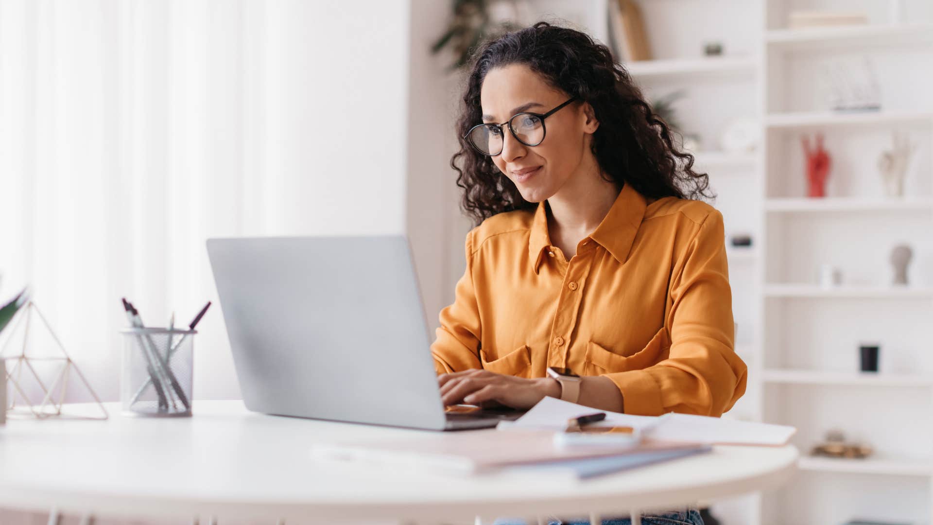 woman working on laptop investing in cryptocurrency