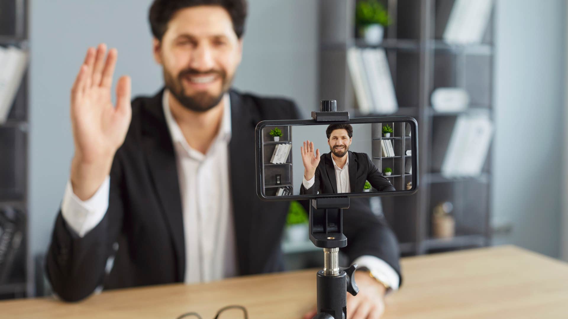 man recording video on phone to go viral online