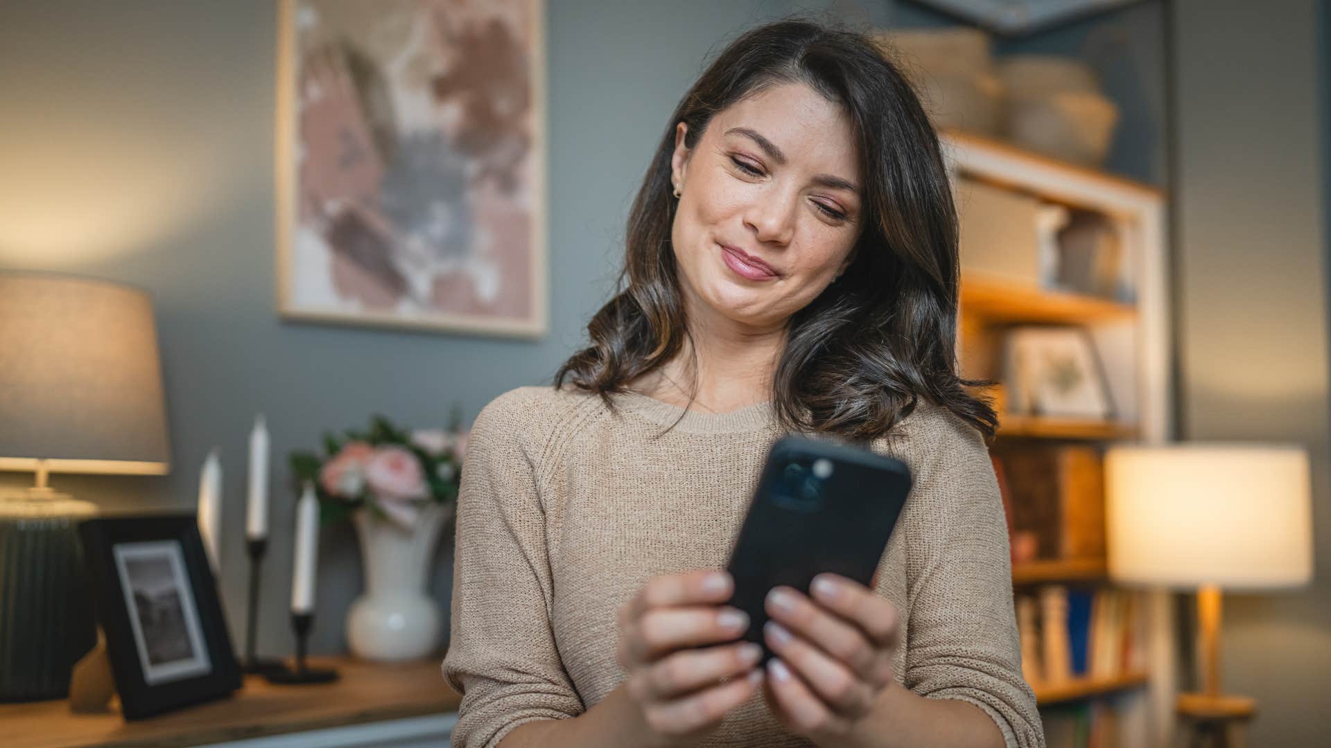 woman looking at phone getting news from influencers on social media