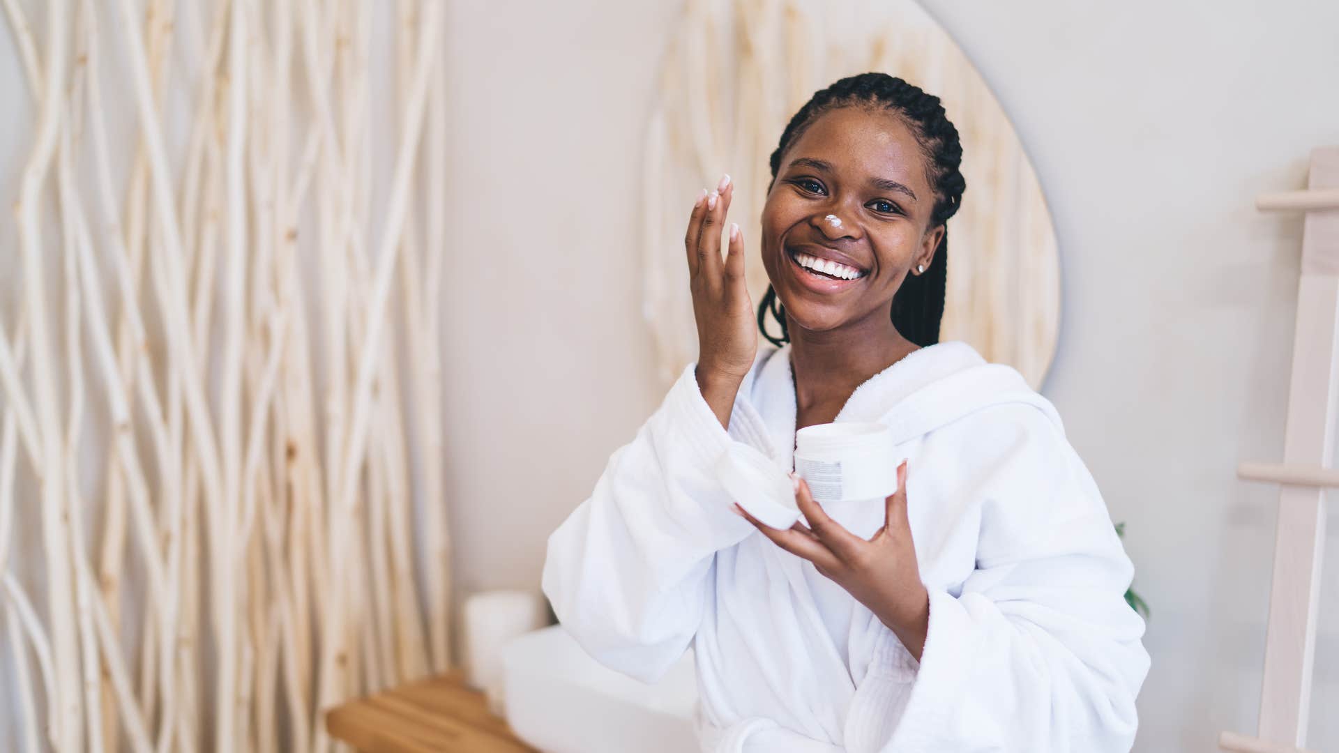 woman practicing self-care doing a face mask in bathroom
